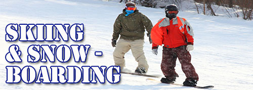 Skiing and Snowboarding - Men snowboarding down snowy mountain slope